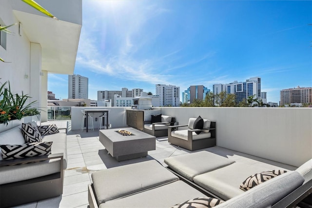 view of patio / terrace featuring an outdoor living space with a fire pit