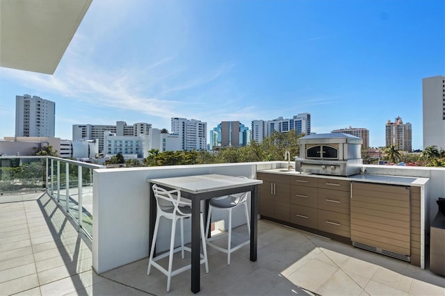 view of patio featuring a balcony and sink