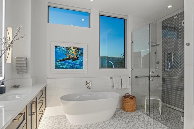 bathroom featuring tile patterned flooring, vanity, an enclosed shower, and tile walls