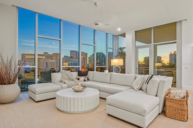 living room with floor to ceiling windows and a healthy amount of sunlight