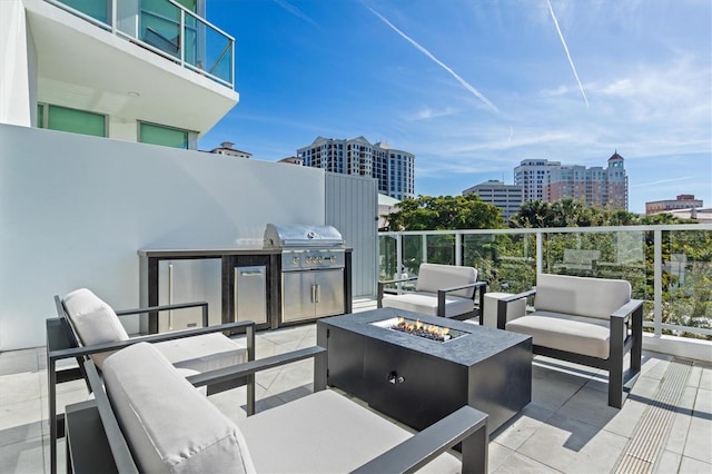 1335 2nd St Unit 301, Sarasota, FL 34236 - view of patio featuring an outdoor living space with a fire pit, a view of city, and exterior kitchen