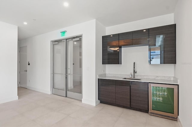 1335 2nd St Unit 301, Sarasota, FL 34236 - kitchen featuring beverage cooler, light countertops, dark brown cabinets, recessed lighting, and modern cabinets
