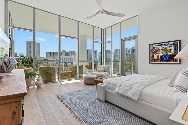 1335 2nd St Unit 301, Sarasota, FL 34236 - bedroom featuring a skyline view, hardwood / wood-style flooring, floor to ceiling windows, access to outside, and a ceiling fan
