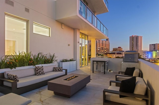 1335 2nd St Unit 301, Sarasota, FL 34236 - view of patio / terrace with an outdoor living space with a fire pit and a city view