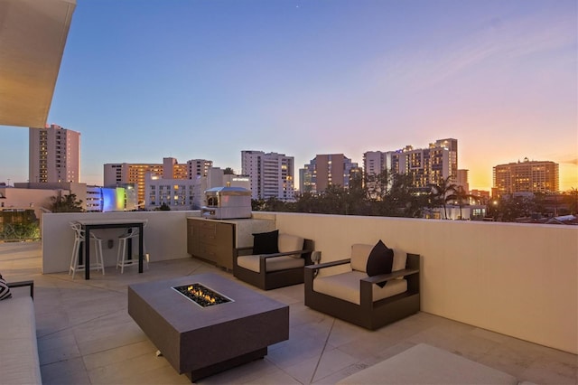 1335 2nd St Unit 301, Sarasota, FL 34236 - patio terrace at dusk featuring a fire pit, a city view, and a patio