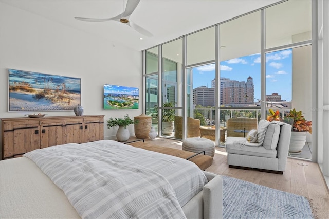 1335 2nd St Unit 301, Sarasota, FL 34236 - bedroom featuring a wall of windows, hardwood / wood-style floors, and a ceiling fan