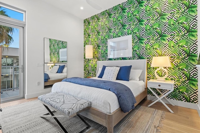 1335 2nd St Unit 301, Sarasota, FL 34236 - bedroom with access to exterior, an accent wall, wood finished floors, a high ceiling, and recessed lighting
