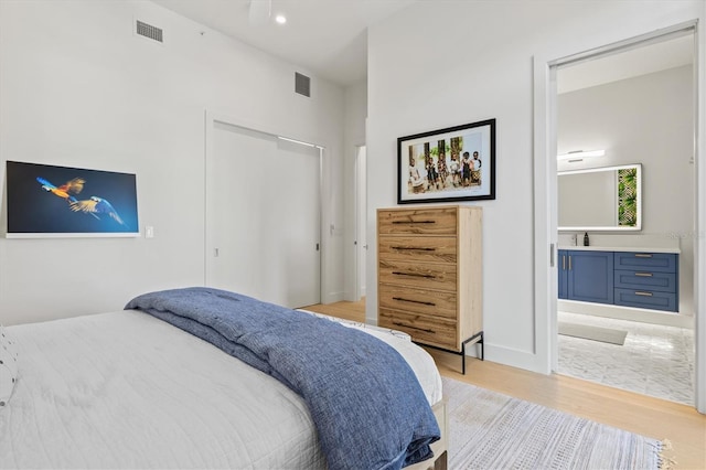 1335 2nd St Unit 301, Sarasota, FL 34236 - bedroom featuring light wood-style floors, ensuite bathroom, and a closet