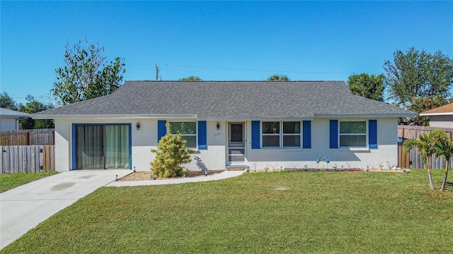 single story home featuring driveway, a front yard, fence, and stucco siding