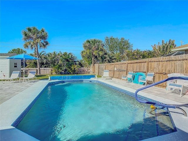 view of swimming pool featuring a fenced in pool, a patio area, and a fenced backyard