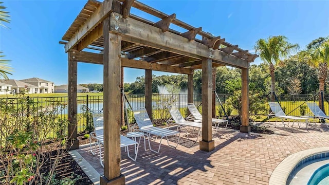 view of patio featuring a pergola and a water view