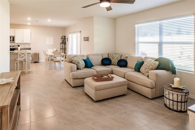 tiled living room featuring ceiling fan