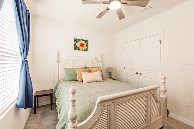 bedroom featuring ceiling fan, light colored carpet, and a closet