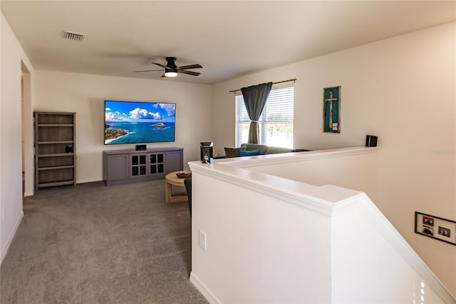 living room featuring carpet and ceiling fan