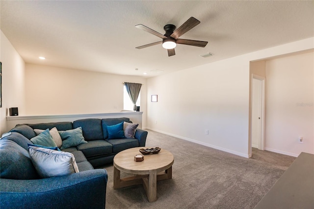 carpeted living room with ceiling fan