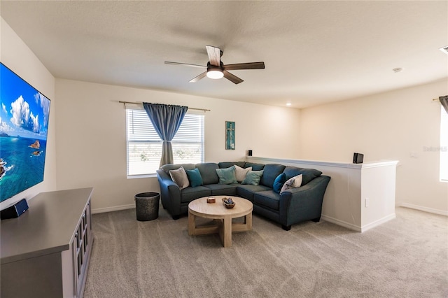 living room featuring light carpet and ceiling fan