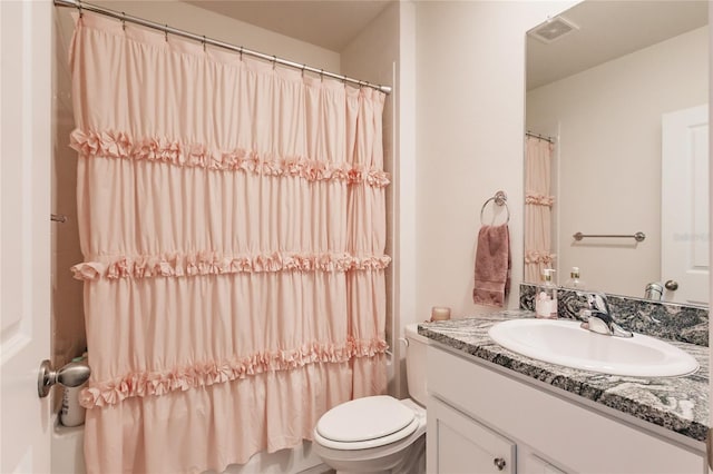 bathroom featuring vanity and toilet