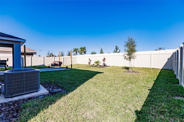 view of yard featuring cooling unit and a patio area