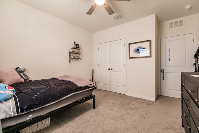 carpeted bedroom featuring ceiling fan and a closet