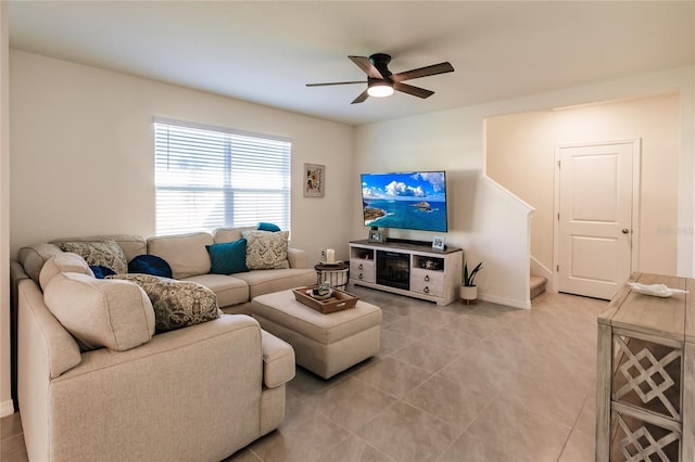 living room with ceiling fan and light tile patterned flooring