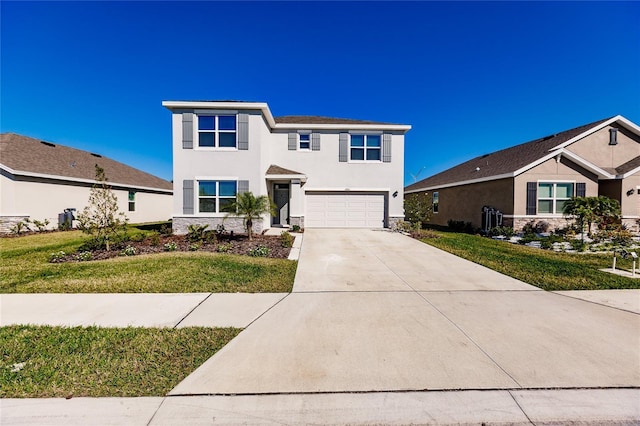 view of front of home with a front yard and a garage