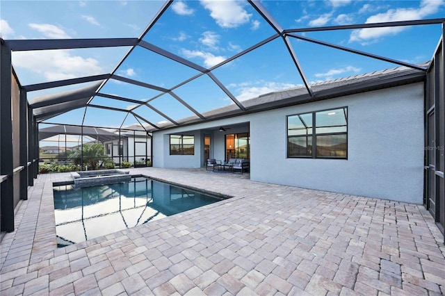 view of swimming pool with glass enclosure, ceiling fan, and a patio area