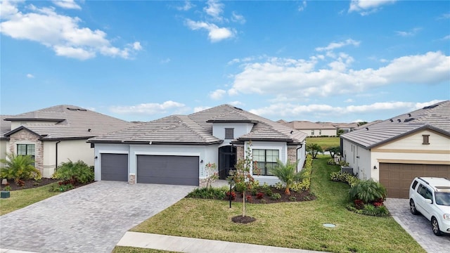 view of front facade featuring a front yard and a garage