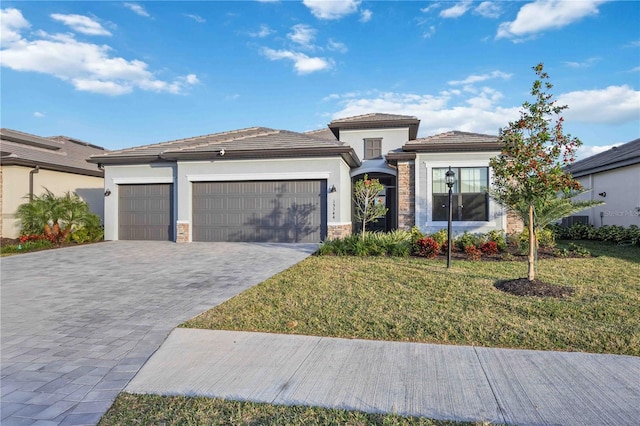 view of front of home featuring a garage and a front lawn