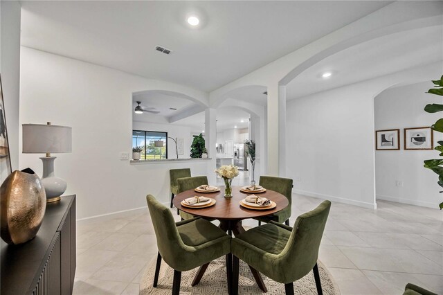 tiled dining room with ceiling fan