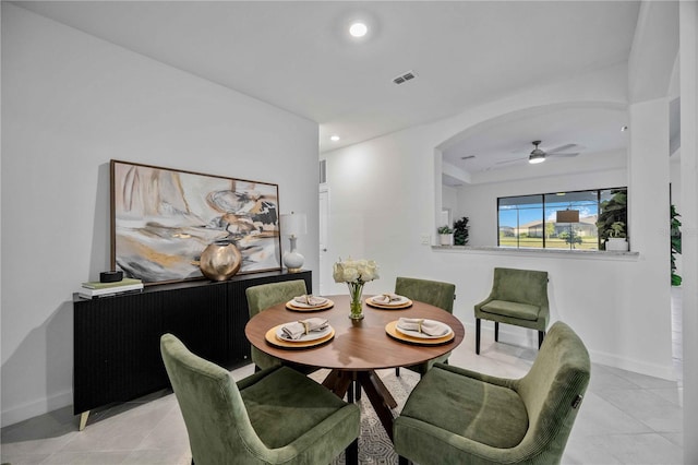 tiled dining room with ceiling fan