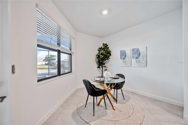 dining space featuring light tile patterned floors and a wealth of natural light