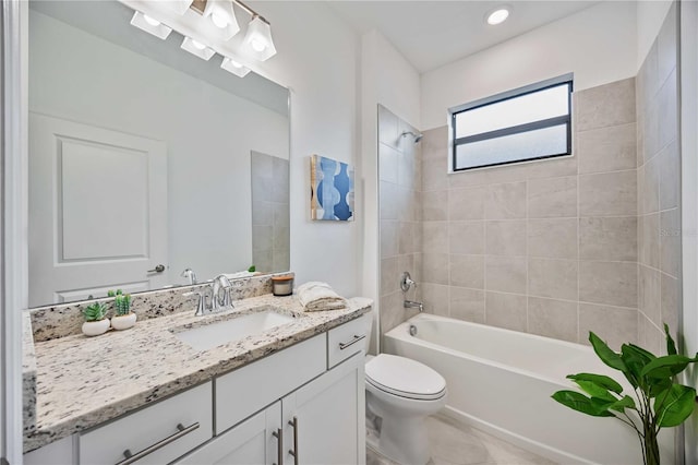 full bathroom featuring tile patterned flooring, vanity, toilet, and tiled shower / bath