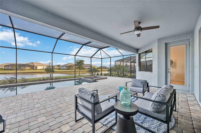 view of patio with outdoor lounge area, ceiling fan, a water view, and glass enclosure