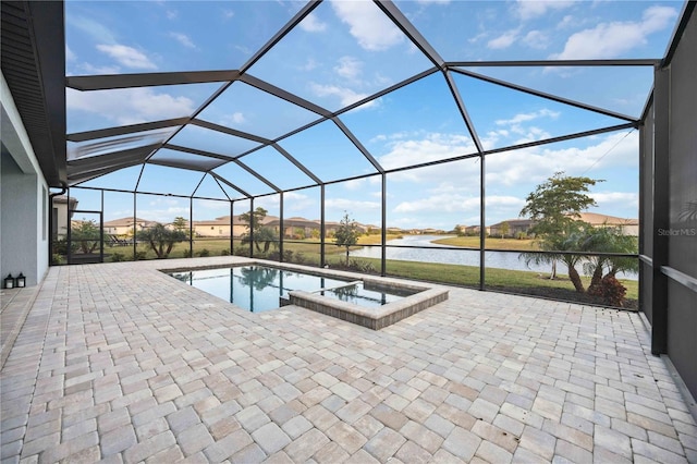 view of pool with glass enclosure, a water view, an in ground hot tub, and a patio