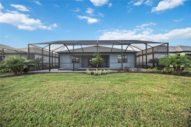 back of property with a lanai and a yard