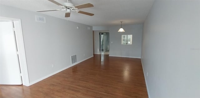 spare room featuring ceiling fan and dark hardwood / wood-style flooring