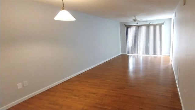 spare room featuring hardwood / wood-style floors and ceiling fan