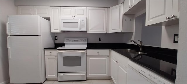 kitchen with white cabinets, light tile patterned floors, white appliances, and sink