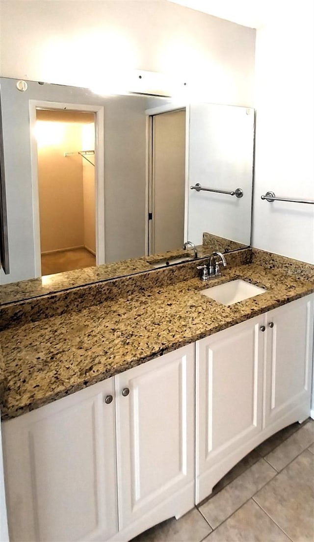 bathroom with tile patterned flooring and vanity