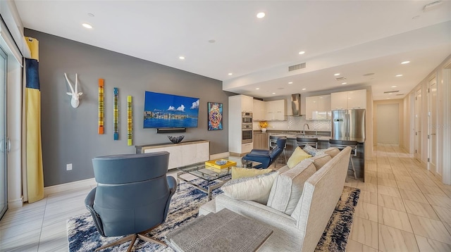 living room with sink and light tile patterned flooring