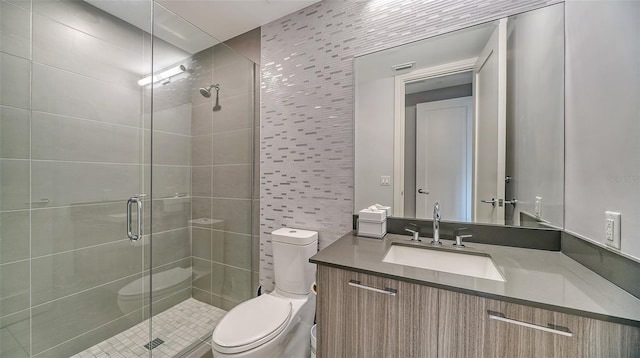 bathroom featuring vanity, toilet, an enclosed shower, and tile walls