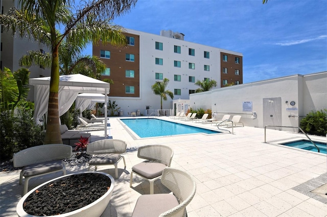 view of pool with a gazebo, a patio, and a hot tub