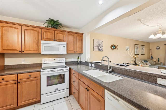 kitchen featuring light tile patterned floors, white appliances, a notable chandelier, and sink