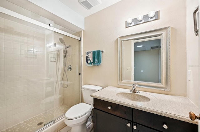 bathroom featuring walk in shower, vanity, and toilet