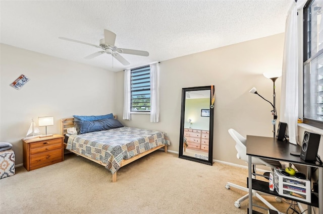 carpeted bedroom with a textured ceiling and ceiling fan