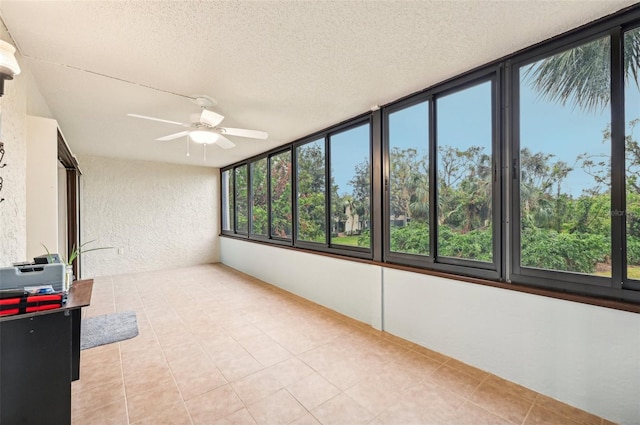 unfurnished sunroom featuring ceiling fan