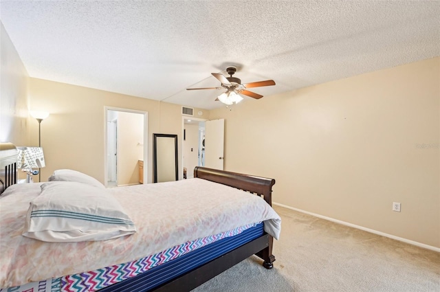 bedroom featuring carpet, ceiling fan, a textured ceiling, and ensuite bath