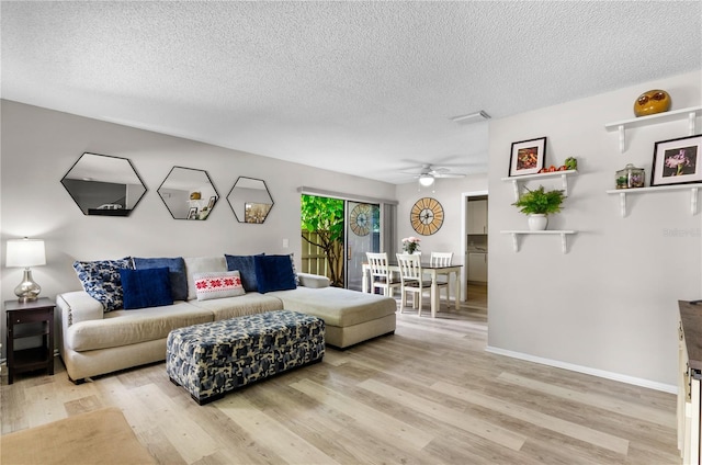 3415 51st Avenue Cir W Unit 206, Bradenton, FL 34210 - living room with a textured ceiling, light wood-style floors, and a ceiling fan