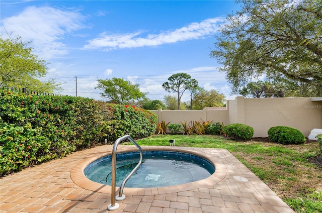 view of swimming pool with an in ground hot tub