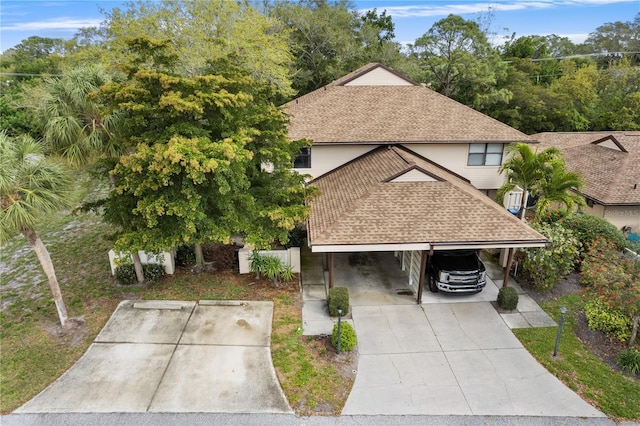 view of front of property featuring a carport and a shingled roof